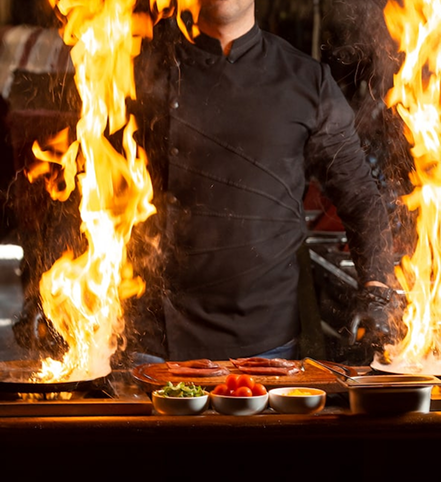 BBQ Nights chef cooking over open flame